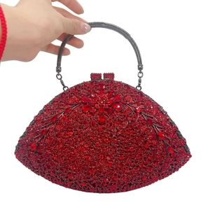 Macro shot of red rhinestone floral clutch with gunmetal handle for evening parties