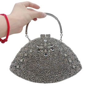 Detail view of silver evening clutch with crystal flower and metal ring handle
