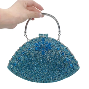 Detailed macro view of royal blue crystal evening clutch with radial rhinestone floral pattern