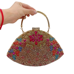 Detail showing colorful rhinestones and floral crystal pattern on a luxury clutch bag