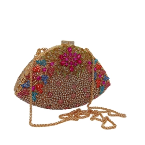 Macro shot of multicolored rhinestone floral evening clutch bag with gold chain