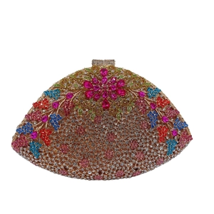 Macro shot of fan-shaped clutch featuring colorful floral rhinestones and pink crystals