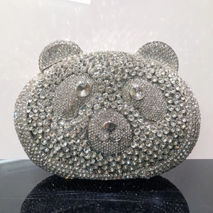 Detailed view of silver panda-shaped evening clutch bag with sparkling diamond-encrusted surface