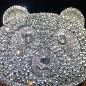 Detailed close-up of bear-shaped dinner clutch with shimmering silver crystals