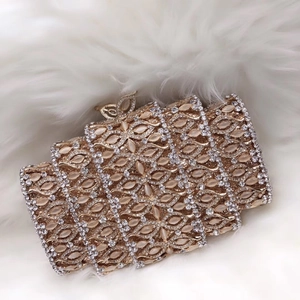 Detailed view of luxury gold evening clutch with rhinestones and butterfly clasp