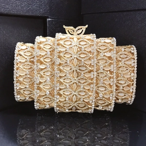 Macro view of golden evening clutch featuring metallic mesh, white gems and crystal stones