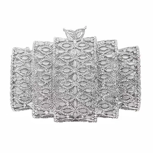 Silver rhinestone evening clutch with tiered design and leaf metal clasp on white background