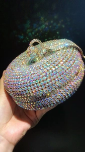 Detailed view of pumpkin-shaped evening clutch bag encrusted with colorful AB crystals