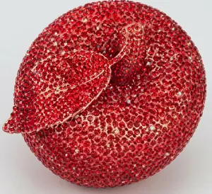 Macro shot of red apple-shaped evening clutch bag with sparkling rhinestone encrusting
