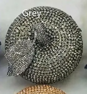 Close-up of grey crystal rhinestones on apple shaped evening clutch bag detail
