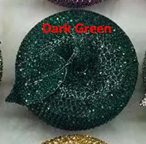 Close-up of deep green apple clutch bag with leaf detail and full rhinestone sparkling surface