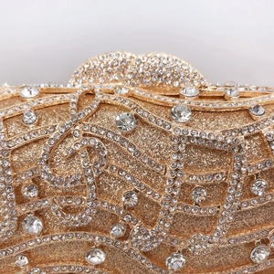 Elegant gold musical note clutch bag with shimmering crystals and treble clef design
