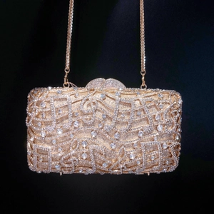 Macro shot of gold evening clutch featuring intricate rhinestones and luxury diamond detailing