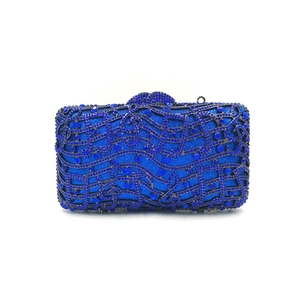 Close-up of royal blue music note evening clutch with rhinestones and metal frame