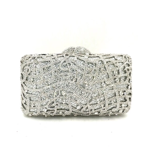 Detailed silver clutch bag featuring hollow music notes and sparkling rhinestones