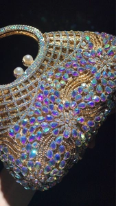 Detailed macro of crystal evening bag with floral rhinestone pattern and pearl clasp