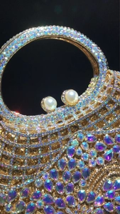 Detail of luxury evening bag featuring colorful rhinestones and teardrop jewels