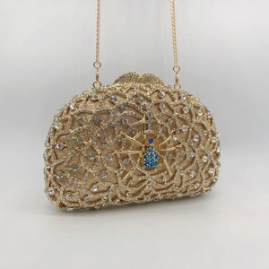 Golden spider clutch bag with shimmering rhinestones and elegant metal chain strap