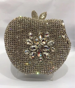 Macro shot of apple-shaped luxury clutch bag with crystal floral pattern and rhinestones