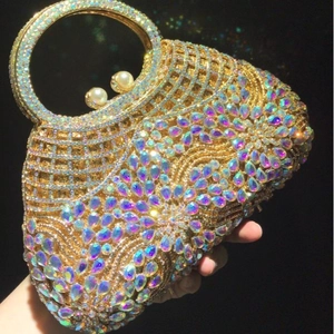 Golden luxury evening bag featuring hollow metal lattice with colorful teardrop crystals