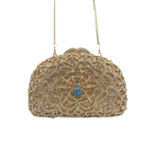 Luxurious gold spider clutch bag with teal gemstones and sparkling rhinestones