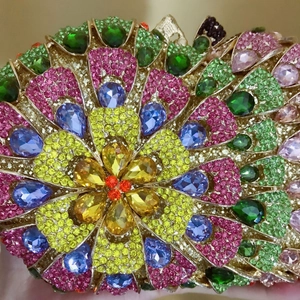 Close-up of luxury evening bag with multi-color rhinestones in a floral pattern