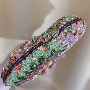 Detailed macro view of colorful rhinestones on a gold metal evening clutch bag