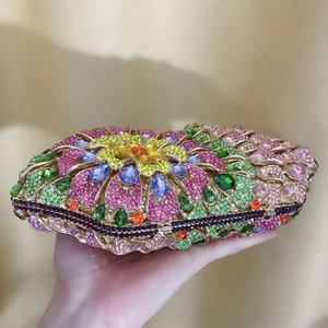 Detailed macro view of heart-shaped evening clutch bag with multicolored crystals