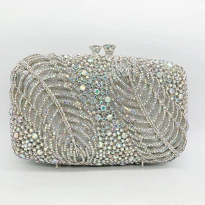 Macro detail of luxury silver rhinestone evening clutch with feather leaf pattern texture