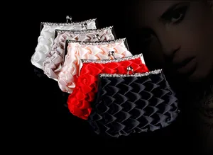 Detail of satin evening clutches with ruched texture and silver spherical metal clasps