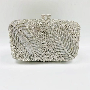 Detailed view of silver evening clutch bag featuring crystal-studded leaf pattern