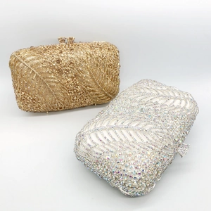 Close-up of sparkling leaf-patterned rhinestone evening clutch in gold and silver