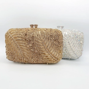 Detailed view of luxury evening clutch bags with intricate leaf-shaped rhinestone patterns