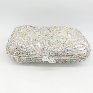Close-up of luxury leaf rhinestone evening clutch with silver hollow metal frame