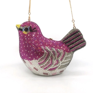 Exquisite bird-shaped clutch bag encrusted with colorful rhinestones and gold chain strap
