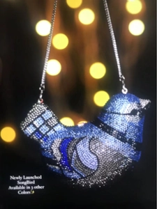 Detailed view of the sparkling blue and gray rhinestone bird-shaped clutch with chain