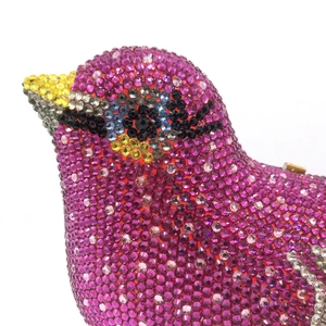 Exquisite bird-shaped dinner clutch bag fully encrusted with vibrant purple rhinestones