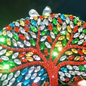 Exquisite hollow metal evening clutch featuring colorful crystal tree of life design