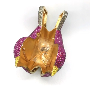 Detail of bird crystal clutch bag showing purple rhinestones and gold chain strap