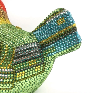 Detailed close-up of bird-shaped evening clutch bag featuring colorful crystal rhinestones