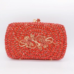 Sparkling red crystal clutch bag with gold hollow floral pattern and luxury metal frame