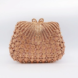 Detail shot of luxury champagne rhinestone shell clutch bag with crystal bow clasp