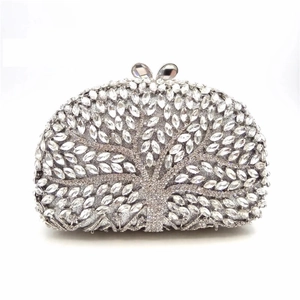 Detailed view of silver hollow tree pattern clutch with radiant marquise rhinestones