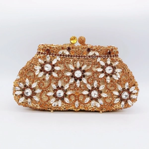 Close-up of luxury floral rhinestone clutch with amber crystals and metal frame clasp