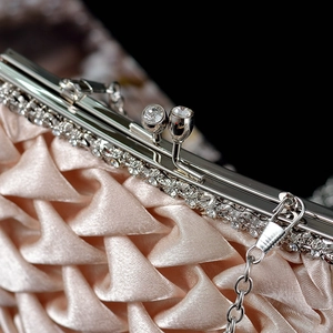 Champagne satin evening clutch bag with pleated texture and crystal clasp on metal frame