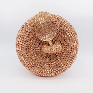Detailed close-up of a hollow-out evening clutch bag with champagne gold rhinestones
