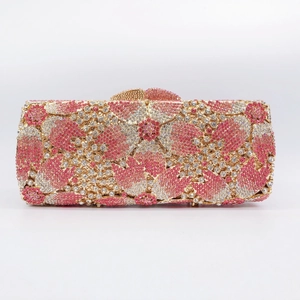 Macro detail of luxury evening clutch bag featuring floral pink and white rhinestones