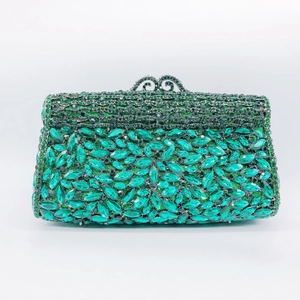 Close-up of emerald green crystal encrusted formal evening clutch bag with ornate clasp