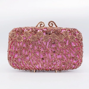 Detailed view of rose gold hollow frame with rhinestones on a luxury evening clutch