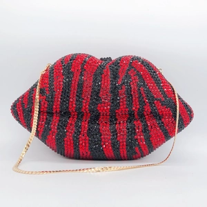 Macro detail of red and black zebra-striped lip clutch bag with full rhinestone embellishments
